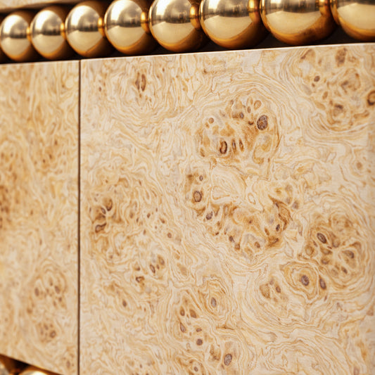 Sculptural luxury sideboard featuring poplar burl and gold-plated steel detailing.