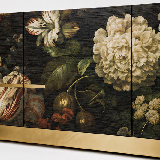 Close-up of the Aurelia sideboard showing layered floral artwork, visible dark oak grain and refined brass detailing.