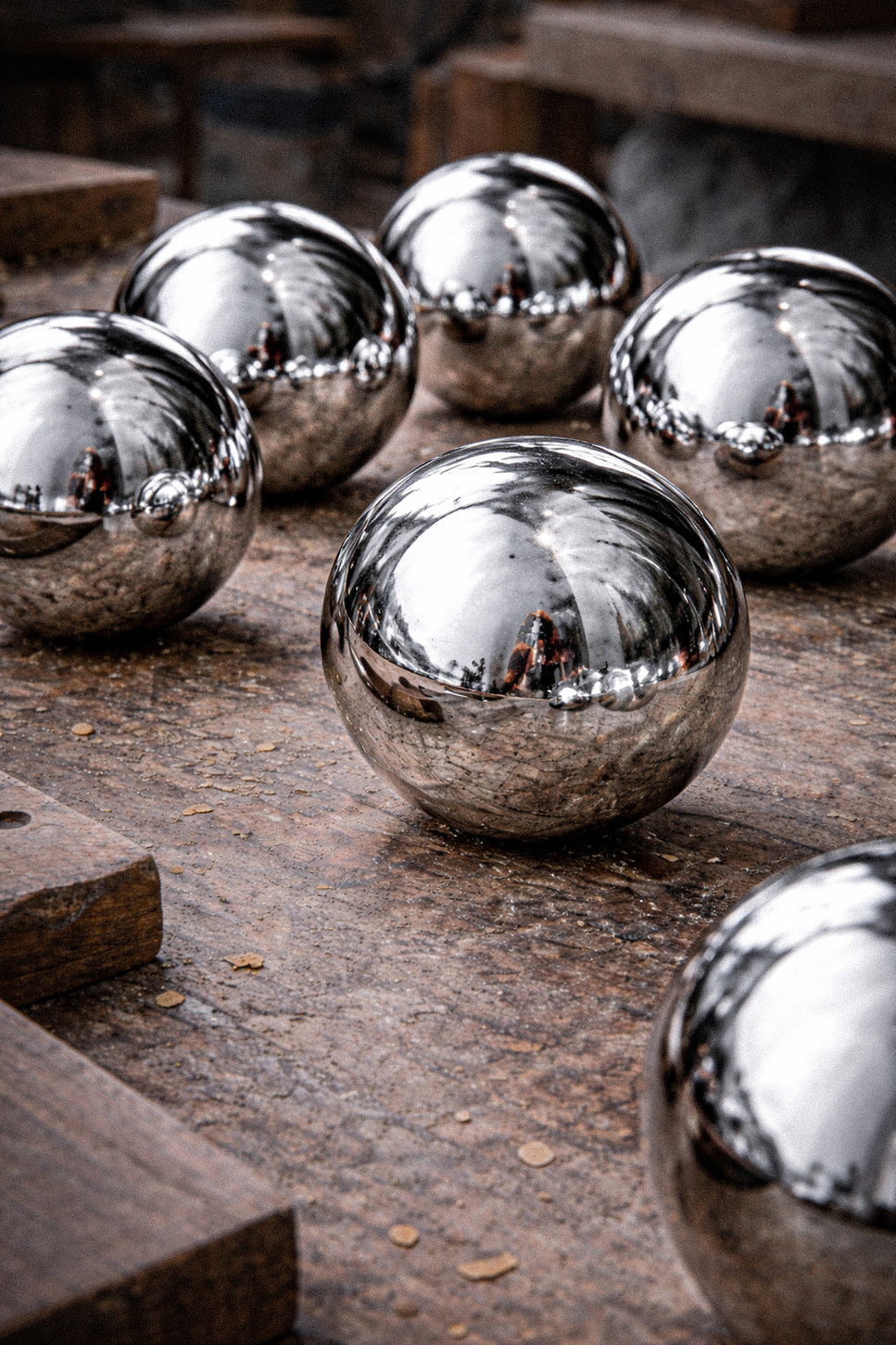 Silver metallic balls on a rustic wooden surface