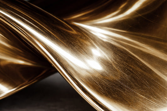 Oval black marble dining table with twisted gold metal pedestal base from Radiance collection.