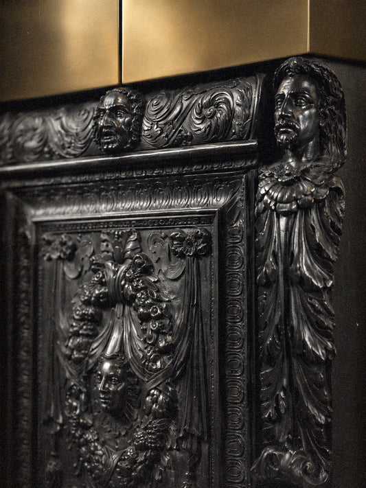 Luxury drinks cabinet with open brass doors, mirrored interior, glass shelves and fine spirits.