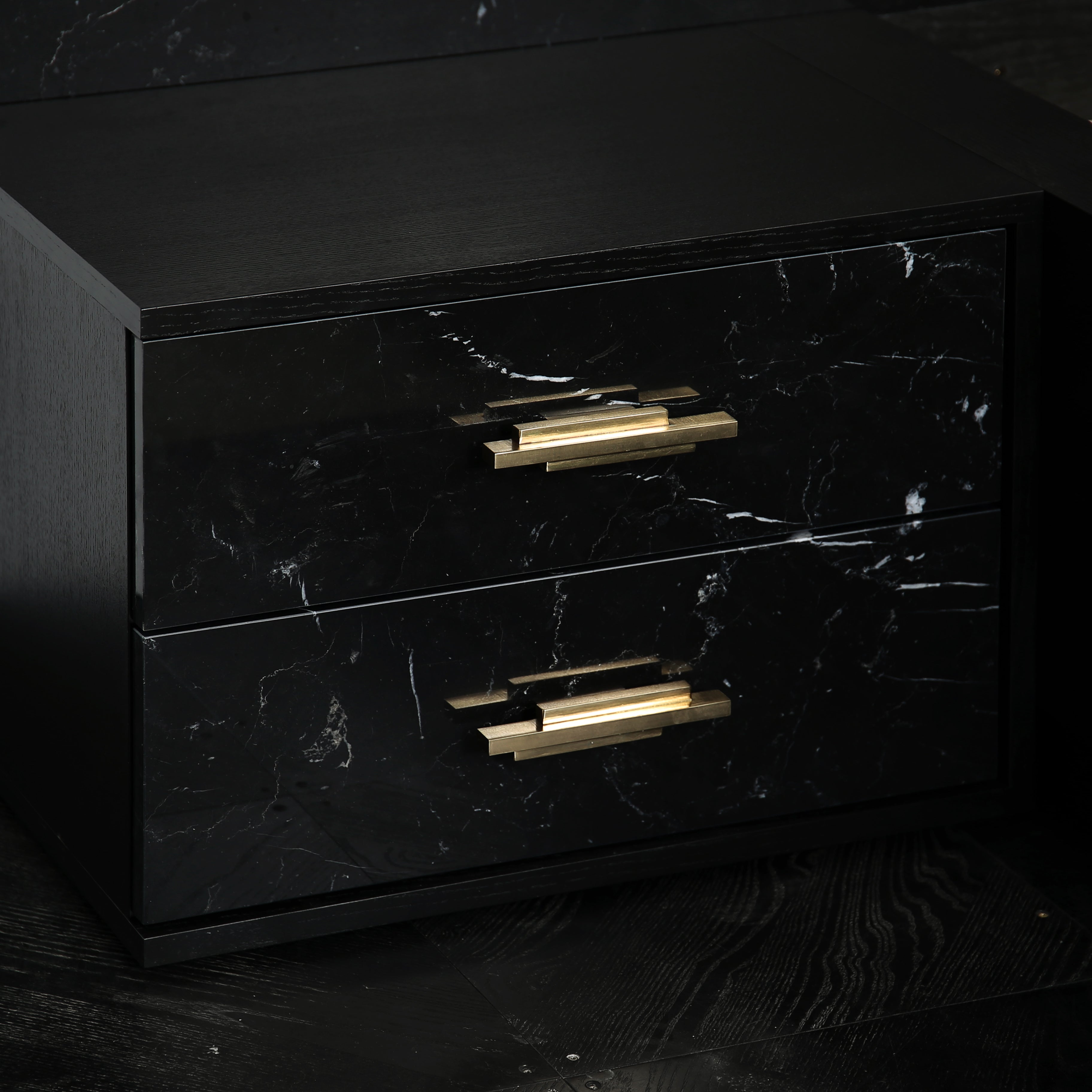 Luxury marble bed with black ash veneer frame and brass drawer pulls.