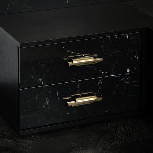 Luxury marble bed with black ash veneer frame and brass drawer pulls.