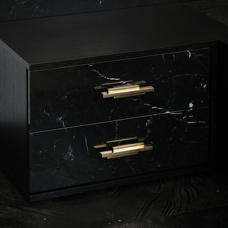 Luxury marble bed with black ash veneer frame and brass drawer pulls.