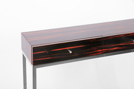 Designer console table combining exotic veneer and polished metal.