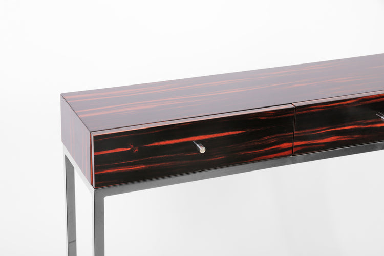 Designer console table combining exotic veneer and polished metal.