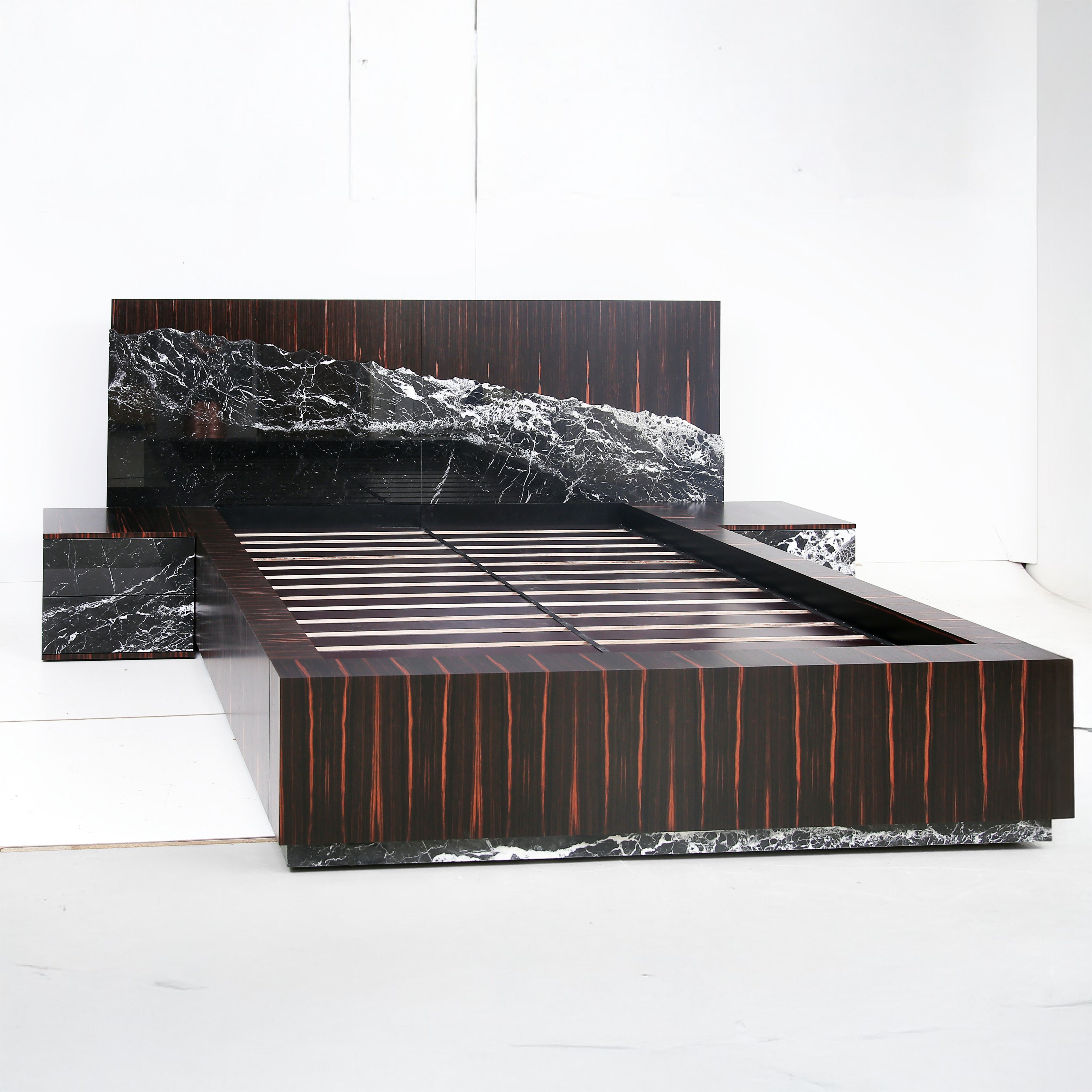 Gullfoss Bed handcrafted in ebony veneer and live-edge Nero Marquina marble, inspired by Iceland’s waterfall.