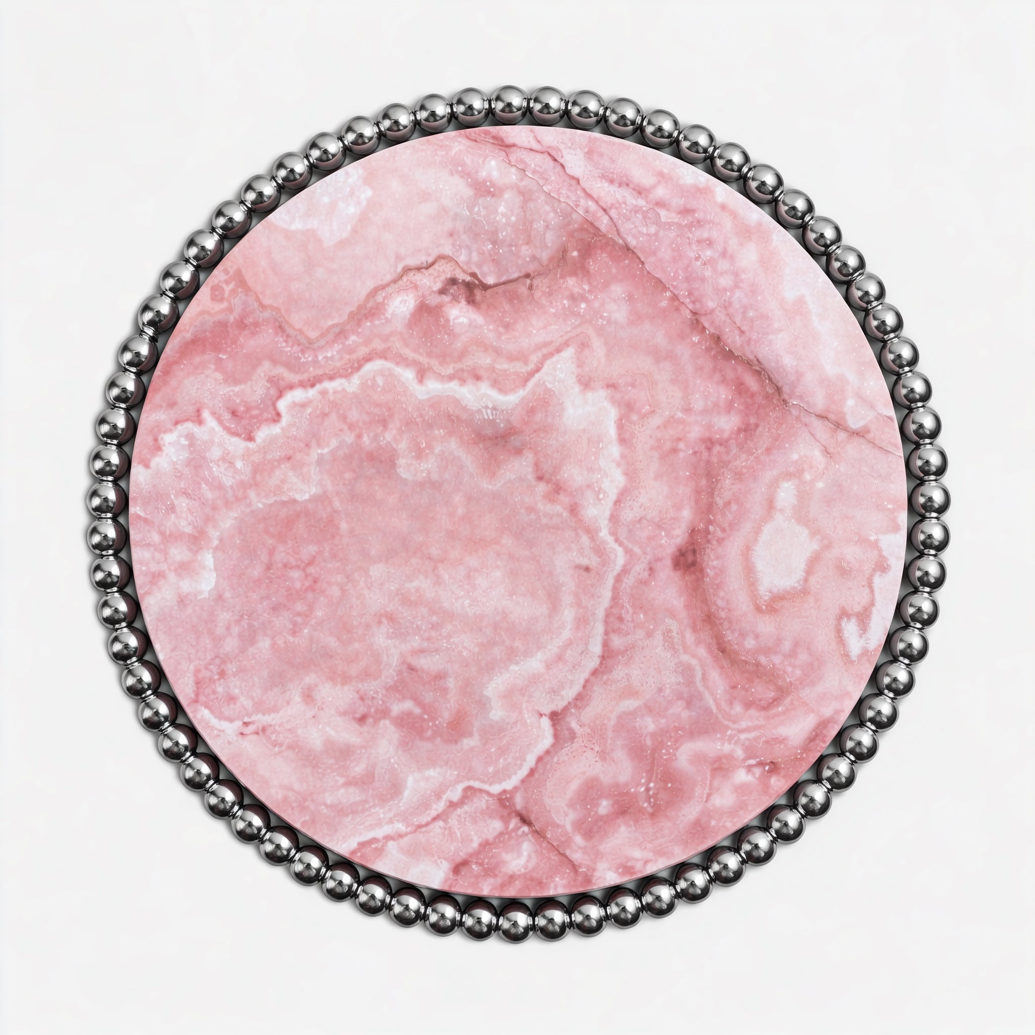 Contemporary luxury dining table with translucent pink onyx surface and reflective metal base.