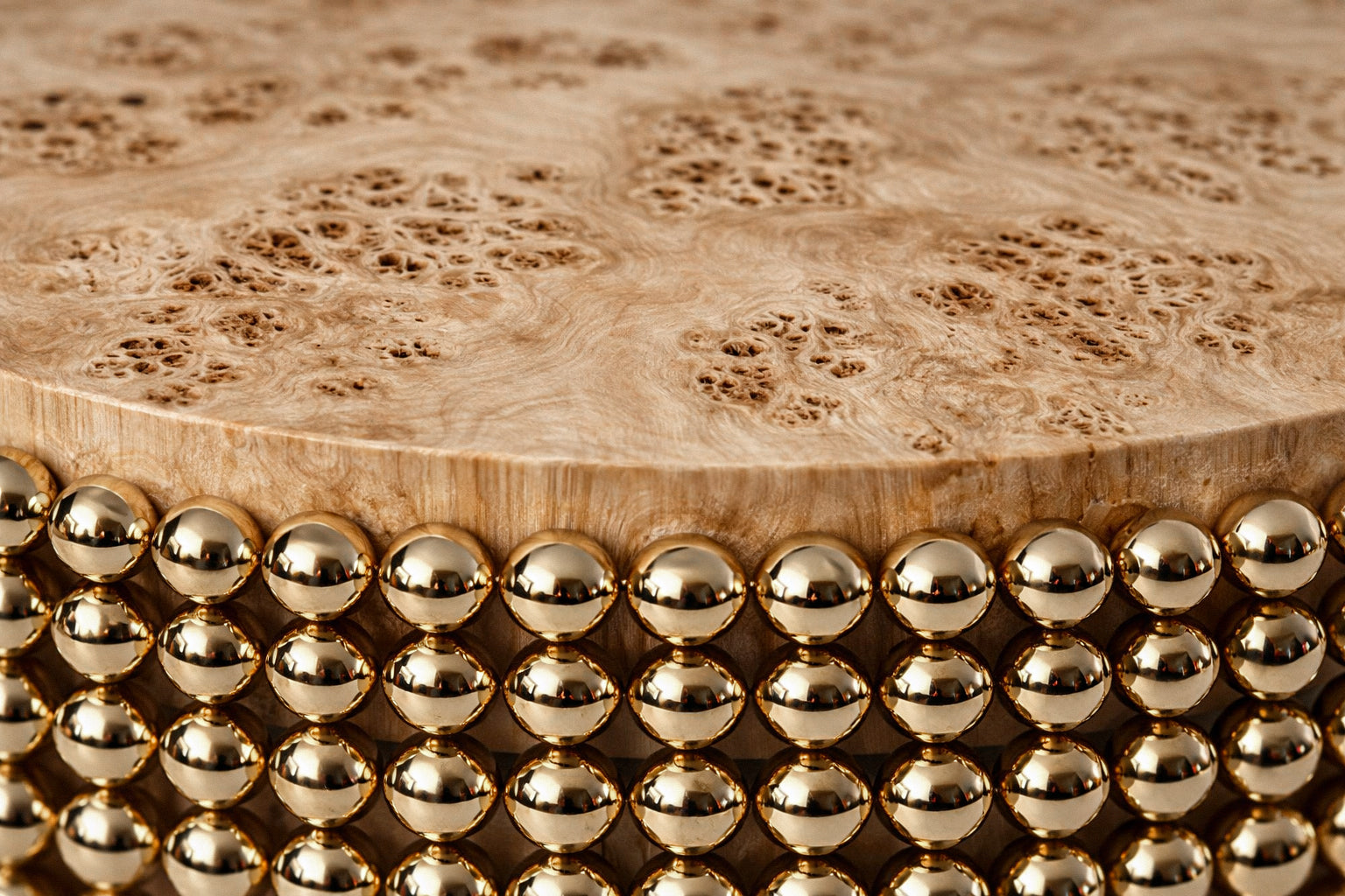Sculptural coffee table featuring gold metal spheres and poplar burl wood surface, designed by Railis Kotlevs