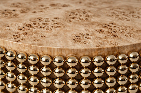Sculptural coffee table featuring gold metal spheres and poplar burl wood surface, designed by Railis Kotlevs