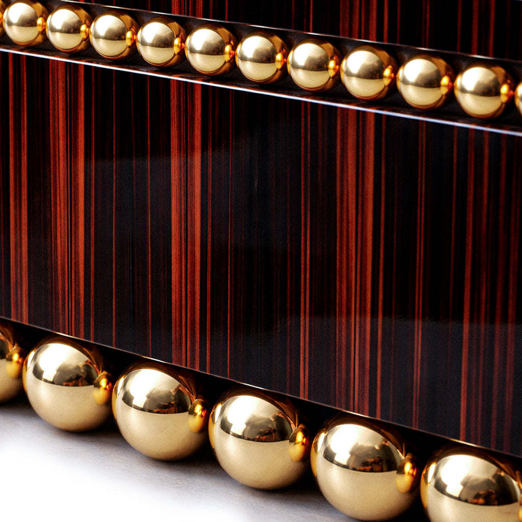 Custom luxury sideboard combining expressive ebony veneer and gold-plated steel.