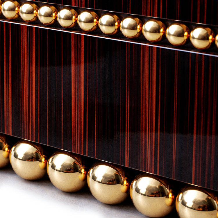 Custom luxury sideboard combining expressive ebony veneer and gold-plated steel.