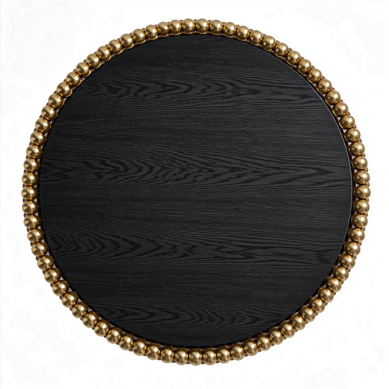 Round dining table in black ash veneer with clustered gold-plated stainless steel spheres