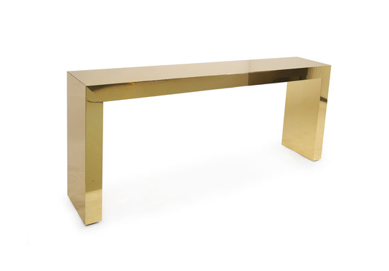 Nova Console in mirror-finish brass HPL placed in a luxury entryway interior.