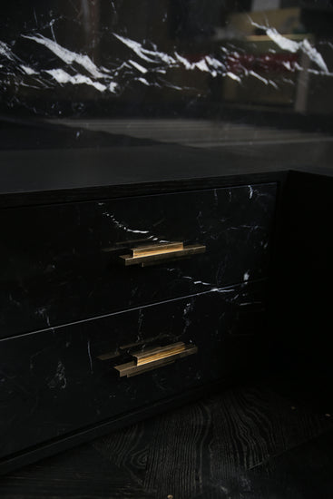 Detail view of brass hardware and marble veining on Dettifoss Bed.