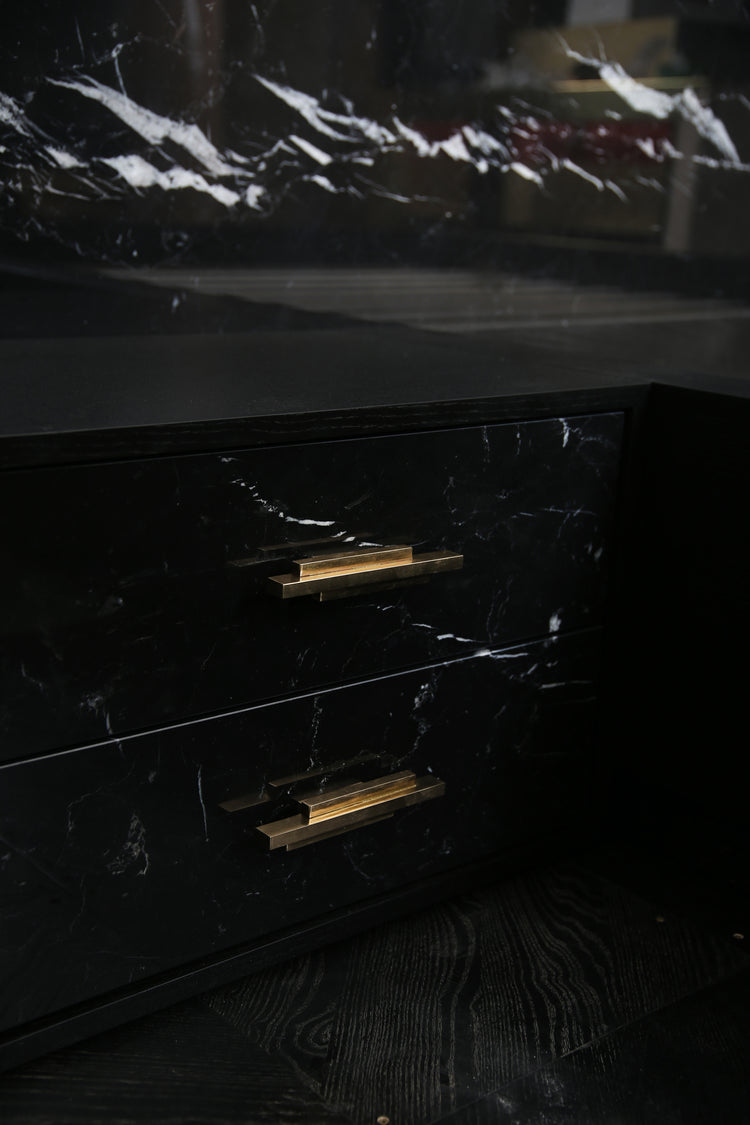 Detail view of brass hardware and marble veining on Dettifoss Bed.