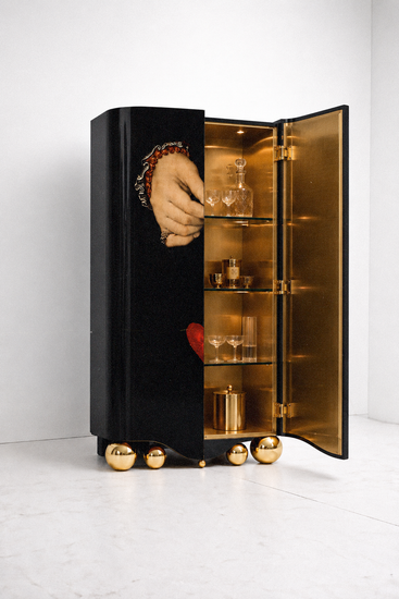 Front view of the Amora drinks cabinet featuring a suspended red heart artwork on a deep-black exterior.