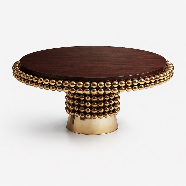 Three-quarter view of the Lustra luxury dining table highlighting its circular wood top and intricate stacked gold sphere base design.