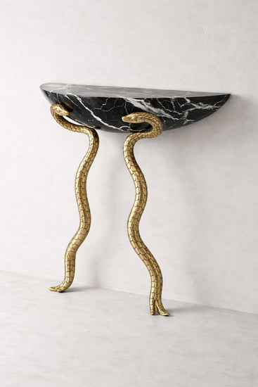 Luxury entryway table with solid marble top and brass-finished snake base.