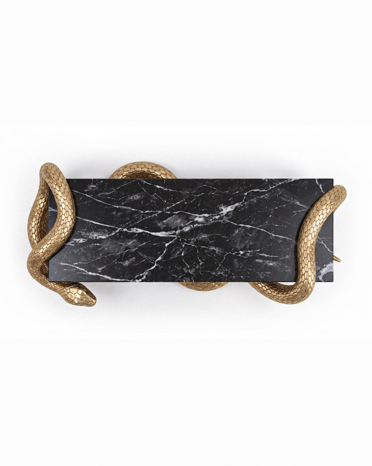 Serpent Coffee Table by Hekla Property featuring Nero marble and an aged-gold sculptural base.