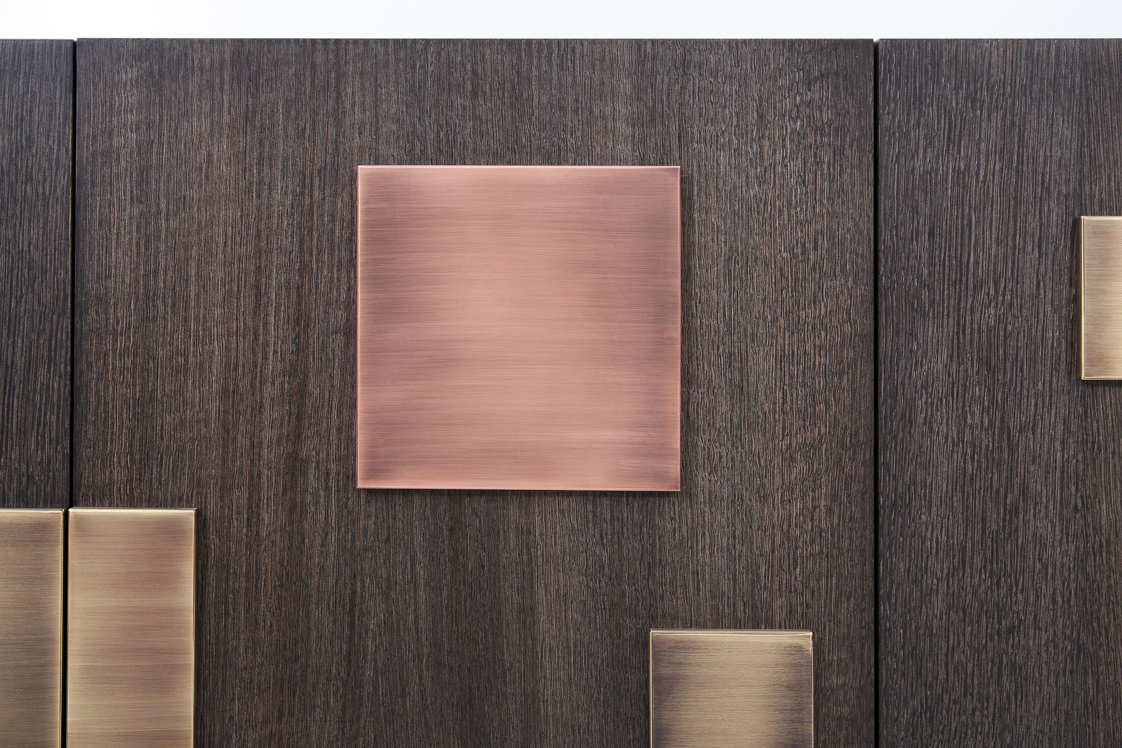 Luxury geometric sideboard handcrafted with solid copper and brass blocks on matte dark oak.