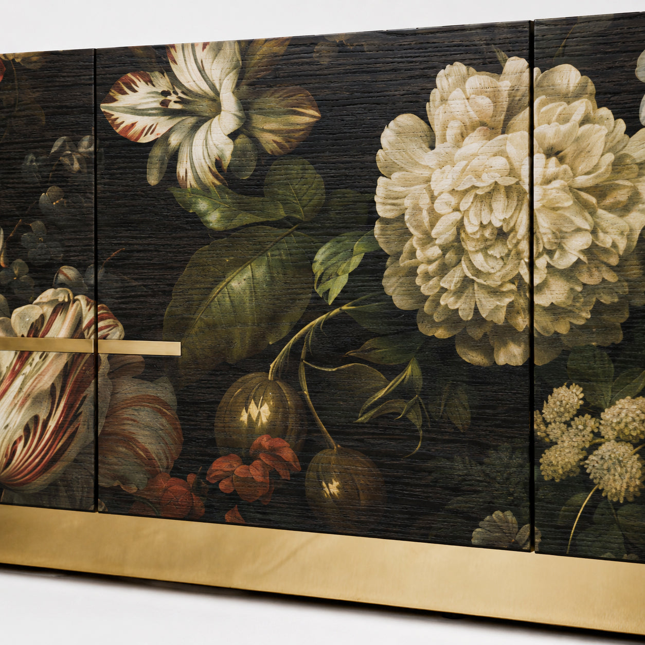 Close-up of the Aurelia sideboard showing layered floral artwork, visible dark oak grain and refined brass detailing.