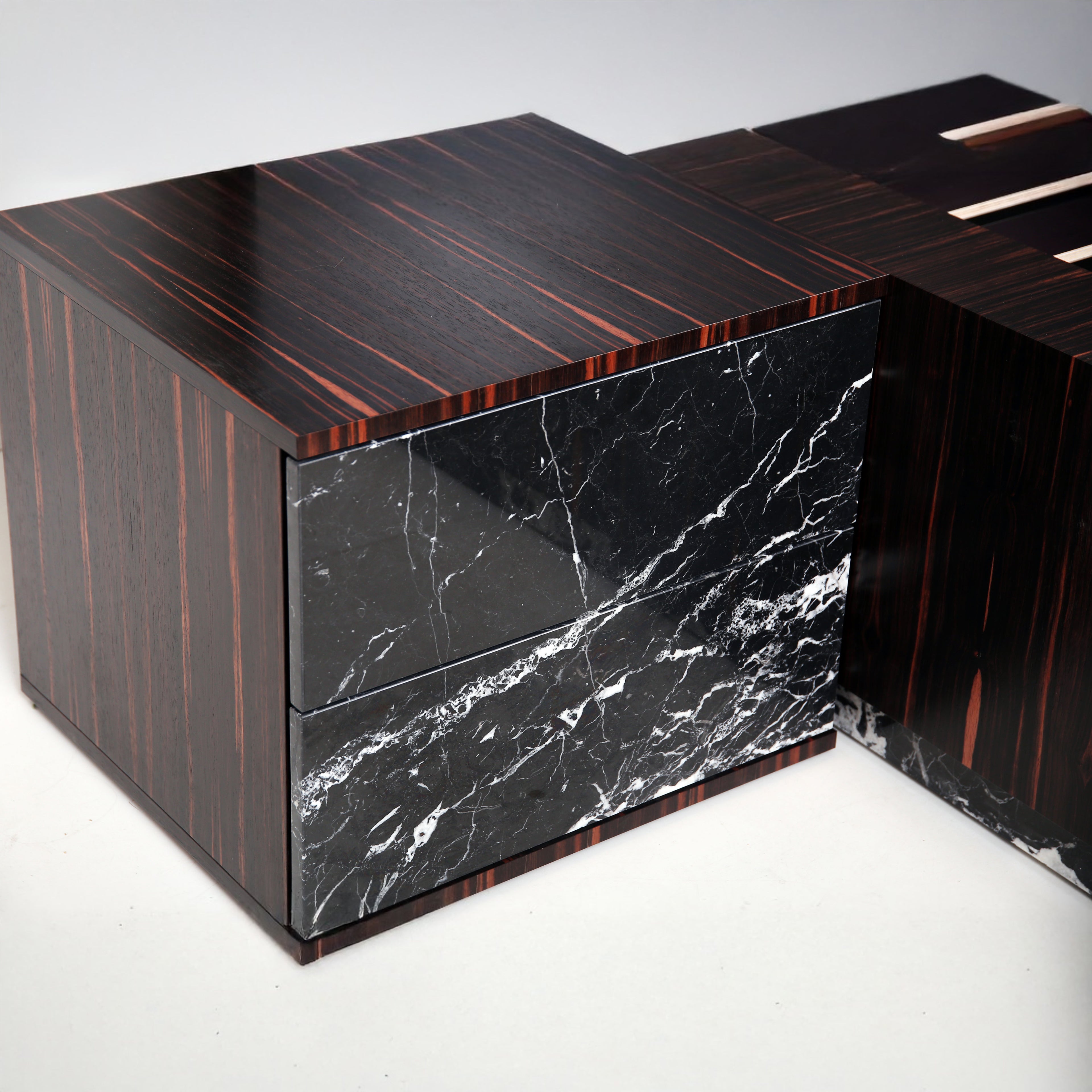 Close-up of live-edge Nero Marquina marble headboard with rich natural veining.