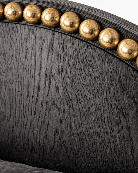 Sculptural luxury bed with arched headboard and metal sphere accents