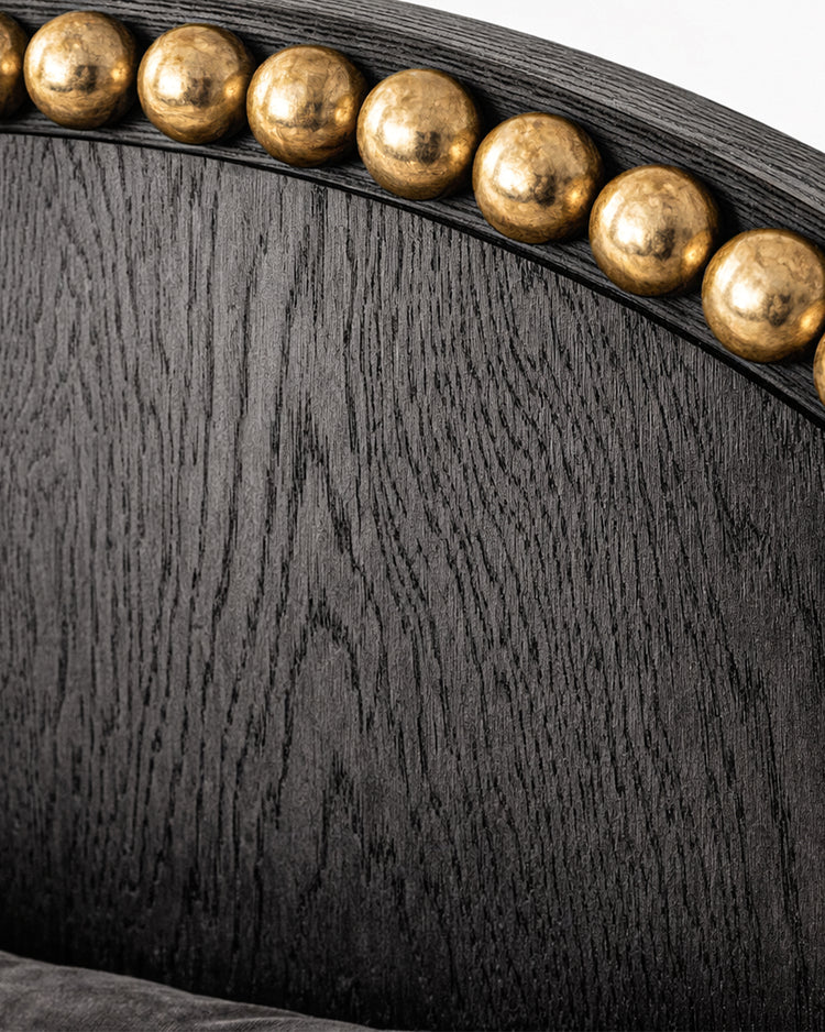 Sculptural luxury bed with arched headboard and metal sphere accents