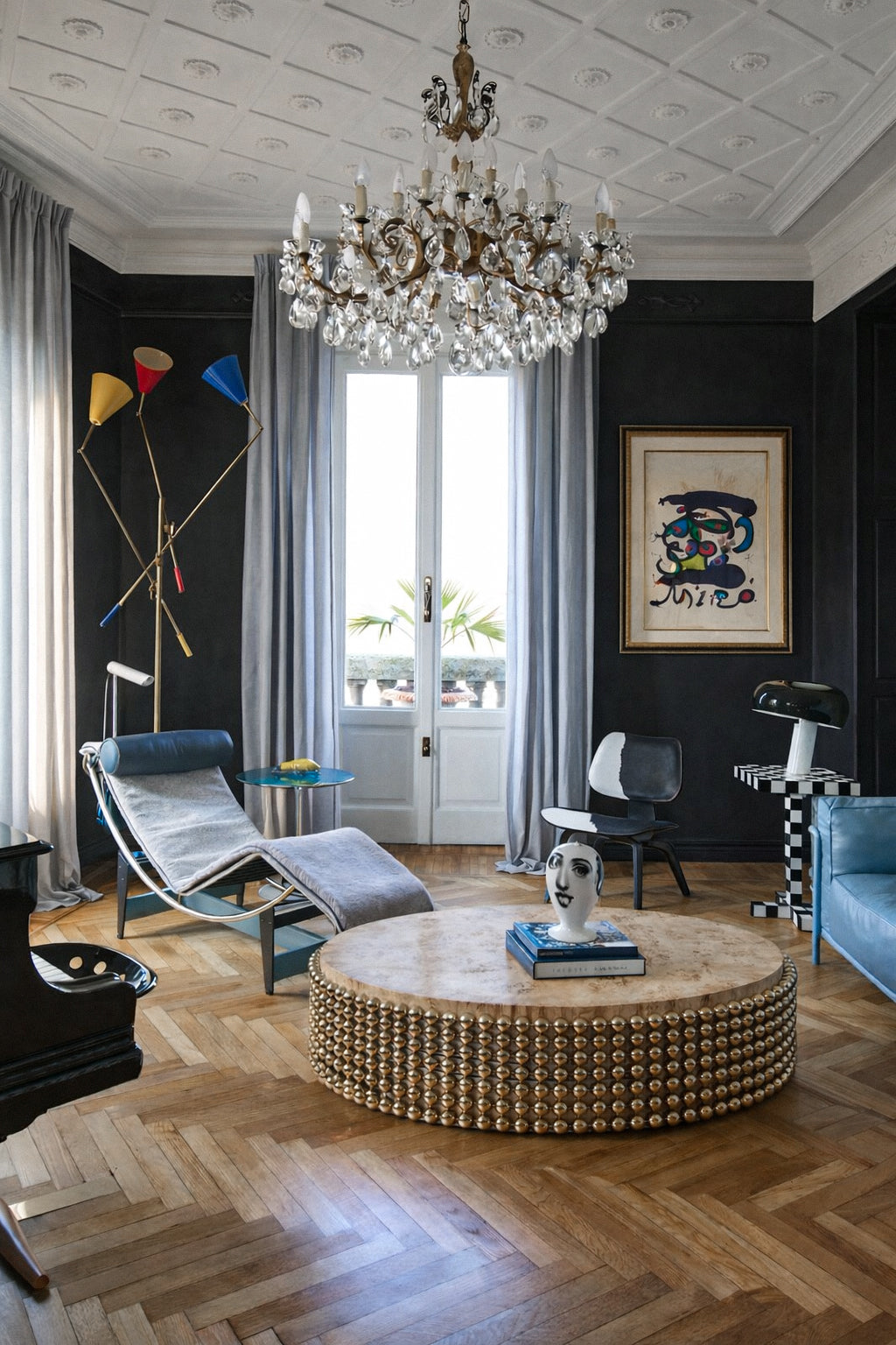 Lustra coffee table in poplar burl with gold sphere base styled in a modern living room, designed by Railis Kotlevs