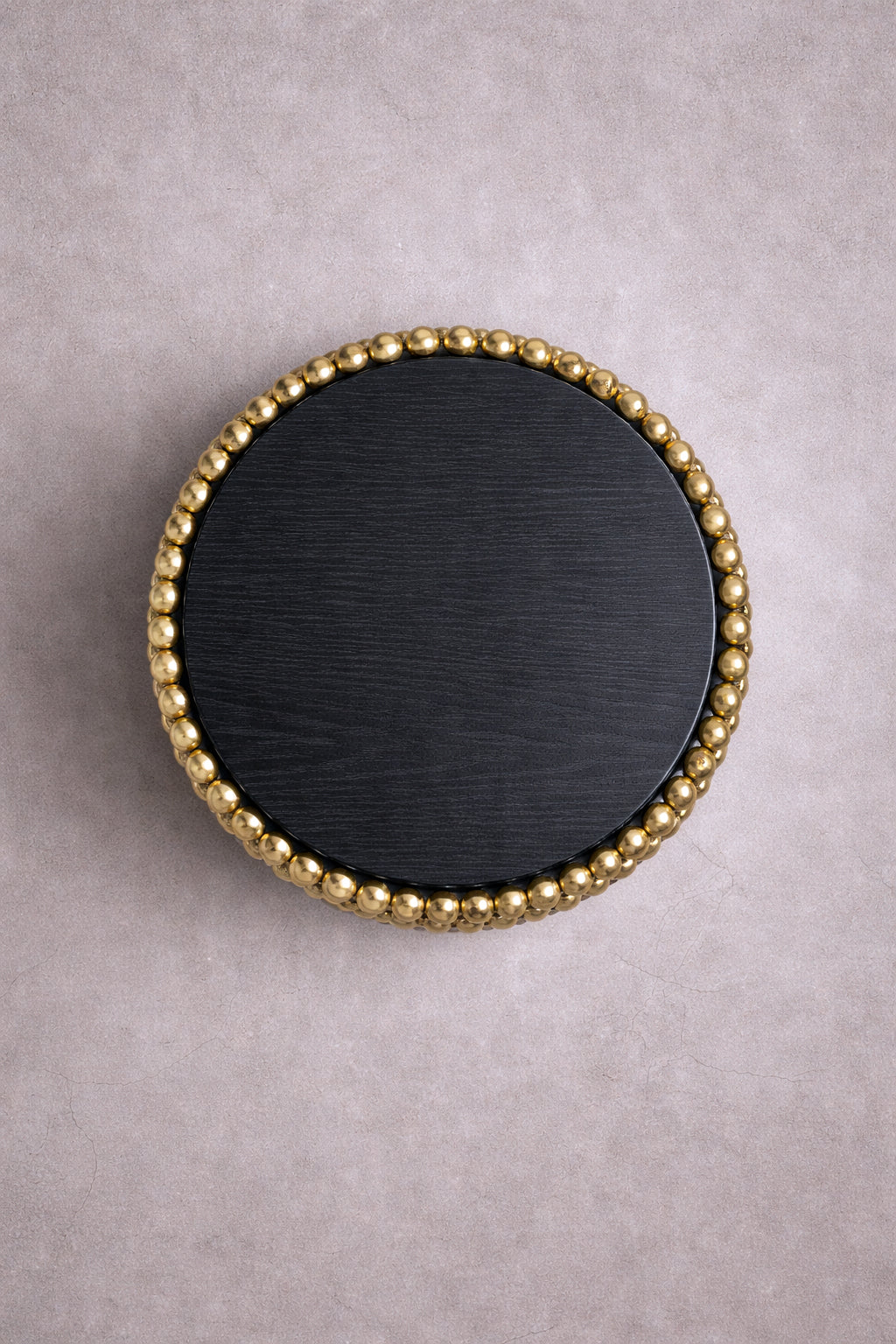 Round side table with reflective gold sphere base and black ash top, designed by Railis Kotlevs