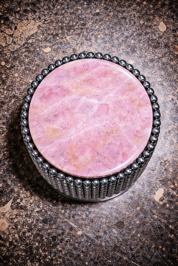Sculptural side table with polished chrome ball base and round pink onyx tabletop