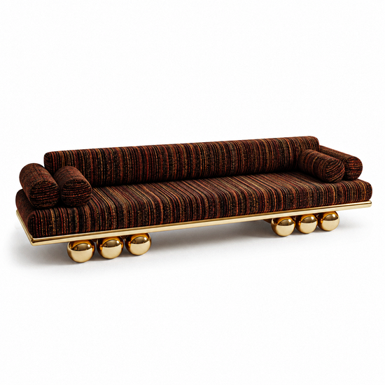 Lustra Sofa by Hekla Property with dark striped woven upholstery, cylindrical cushions, polished gold rail, and sculptural gold sphere legs.