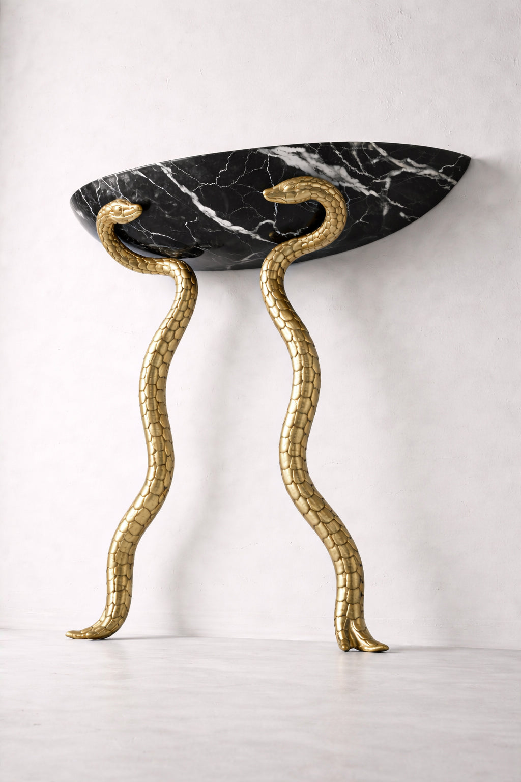 Decorative console table with snake-like legs and black marble top on a white background