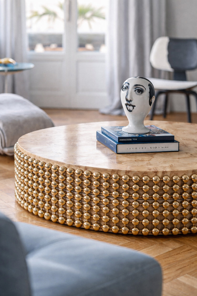 Sculptural poplar burl coffee table with gold spheres placed within a contemporary interior setting, designed by Railis Kotlevs
