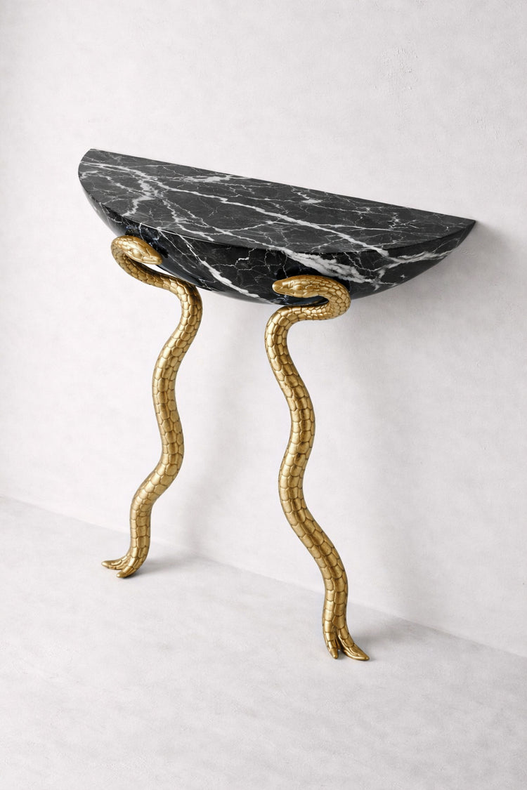 Contemporary console table with liquid metal brass serpents and black marble.
