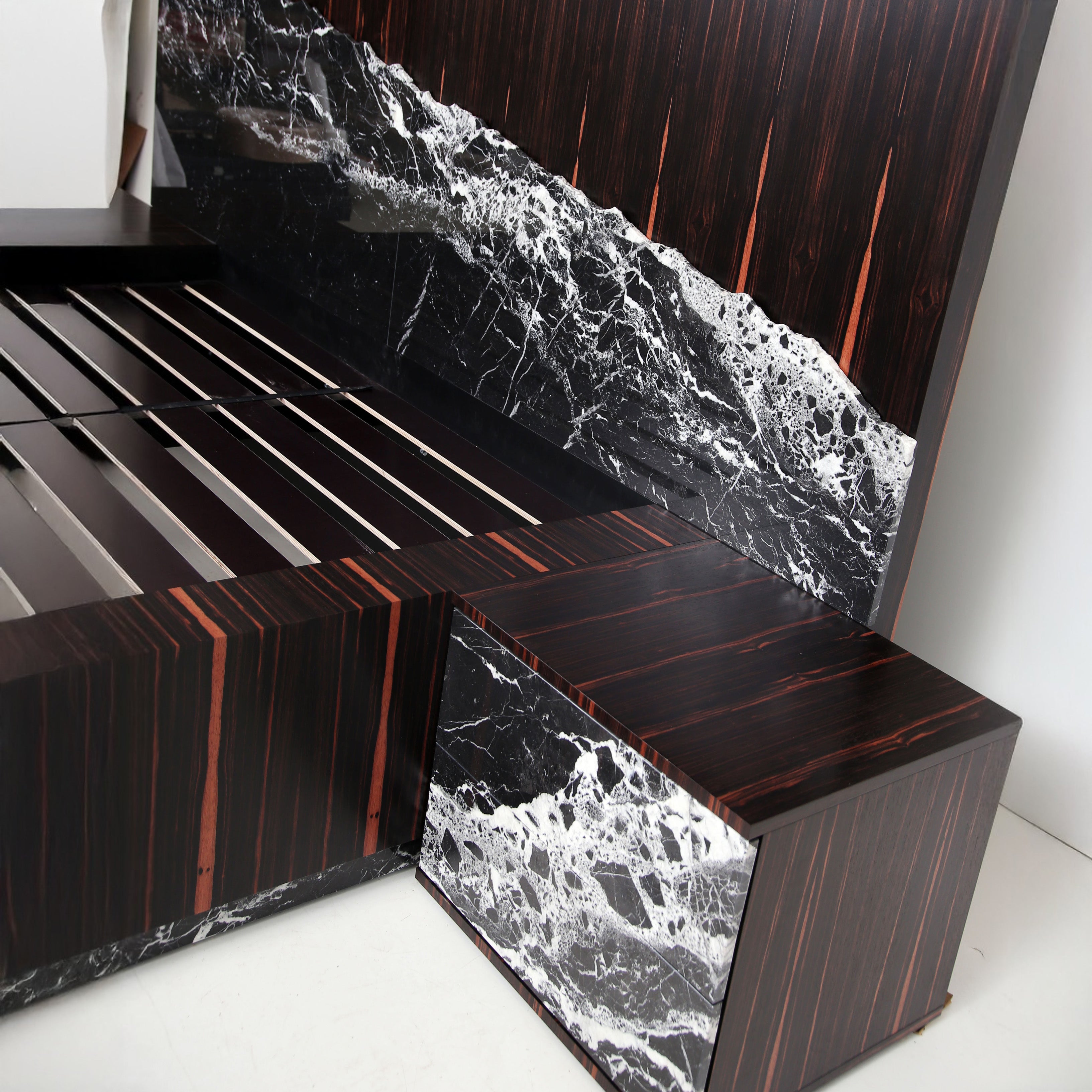 Custom-made bed design with black marble and exotic wood veneer.