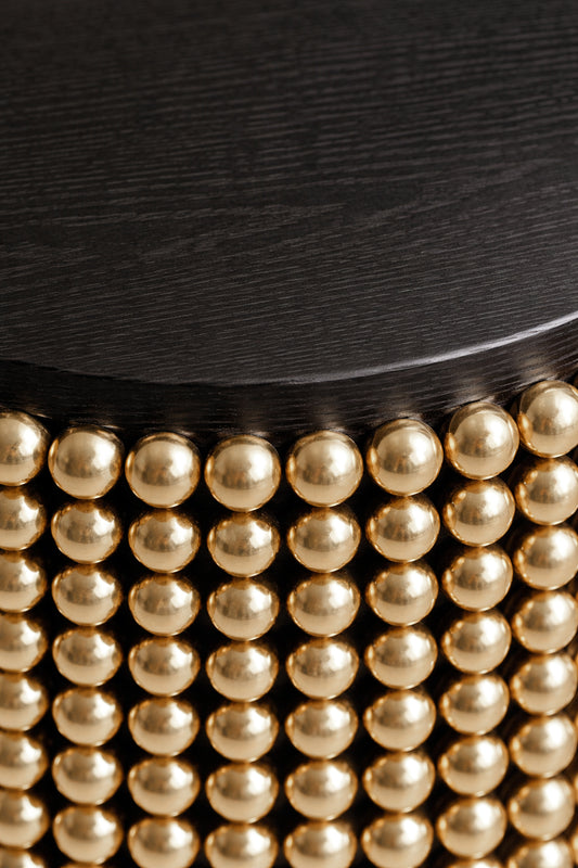 Sculptural side table featuring gold metal spheres and black ash tabletop, designed by Railis Kotlevs