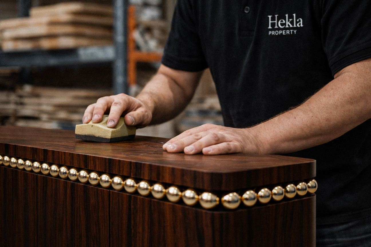 Luxury storage cabinet in wenge veneer with polished gold stainless steel spheres