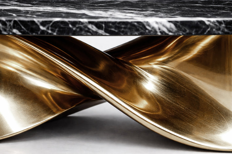 Black marble dining table with bold white veining and fluid gold metal pedestal base.