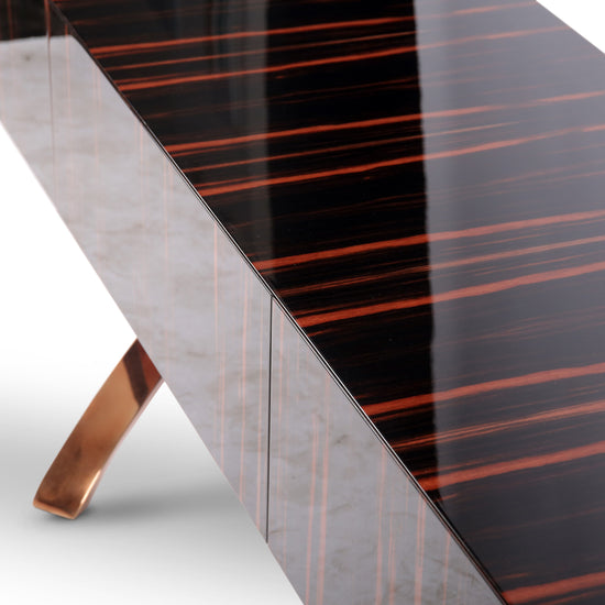 Designer sideboard featuring ebony veneer and gold curved metal base for luxury interiors