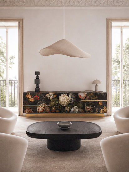 Aurelia sideboard displayed in a refined contemporary interior, combining dark floral artwork, natural oak texture and polished brass details.
