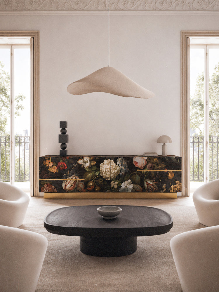 Aurelia sideboard displayed in a refined contemporary interior, combining dark floral artwork, natural oak texture and polished brass details.