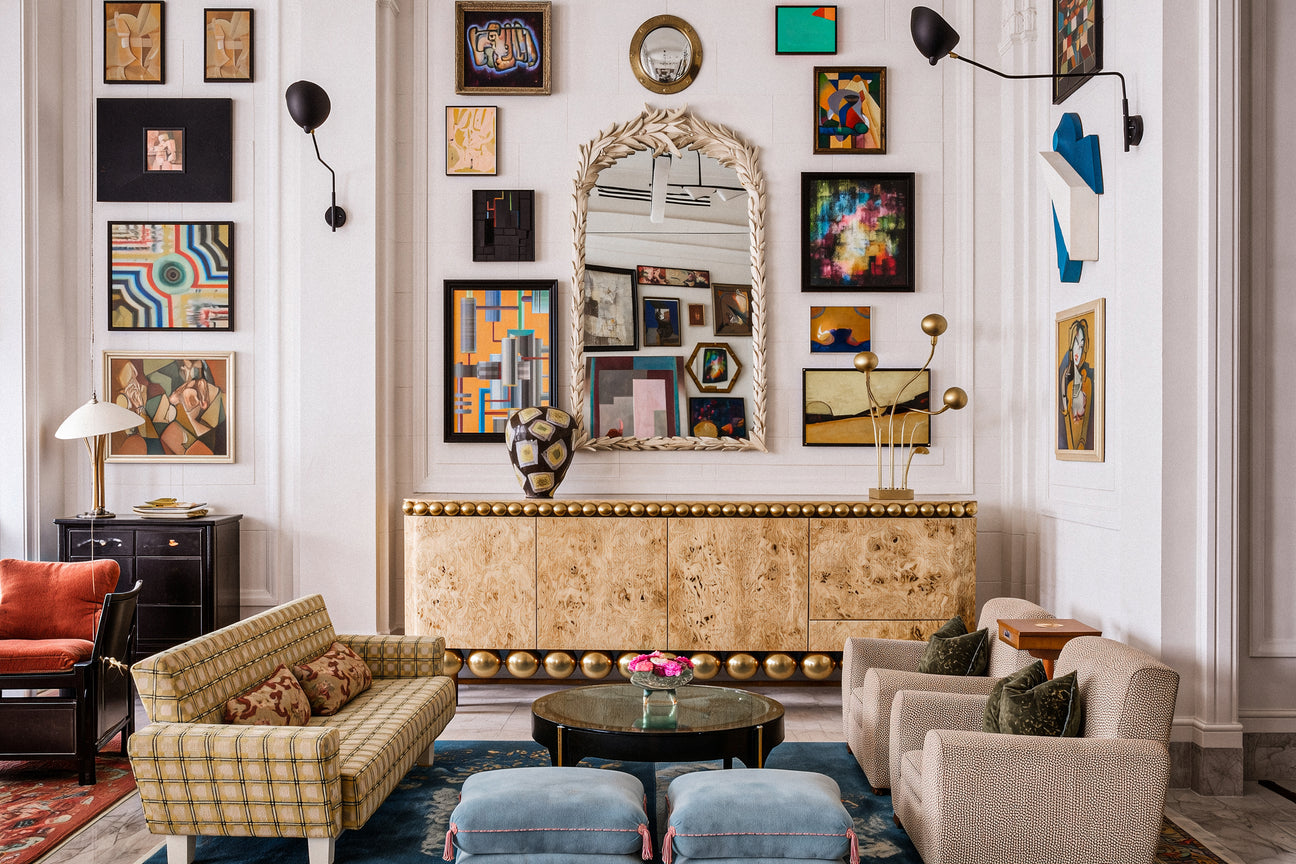 Elegant living room with decorative wall art, furniture, and a gold console table.