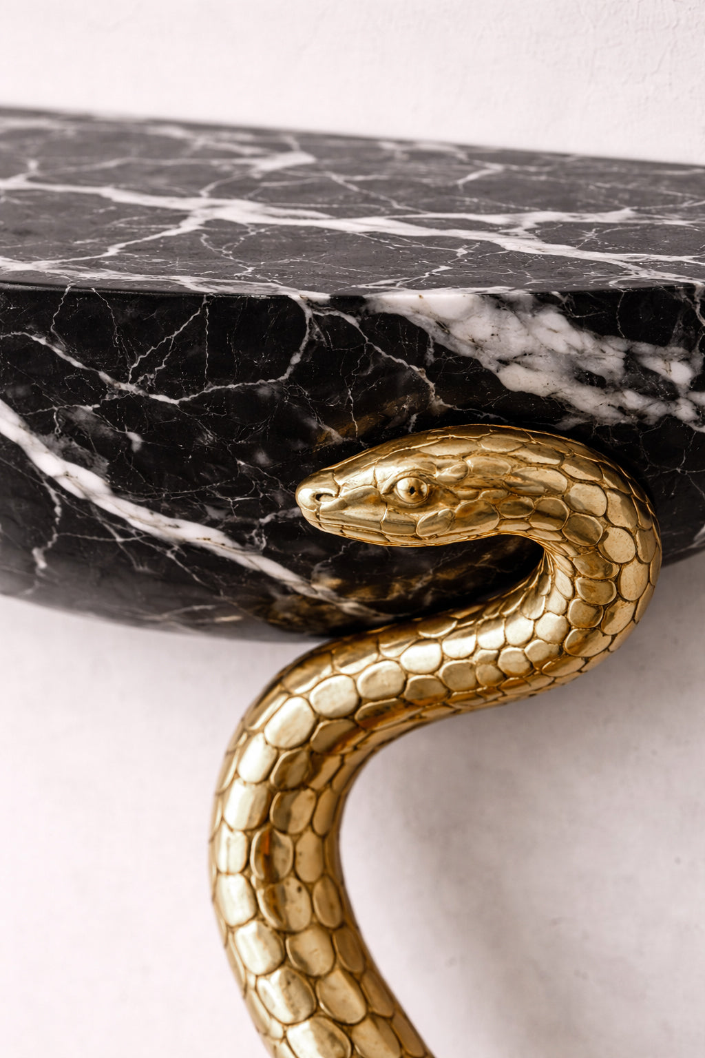 High-end marble console table with handcrafted serpent legs by Hekla Property.