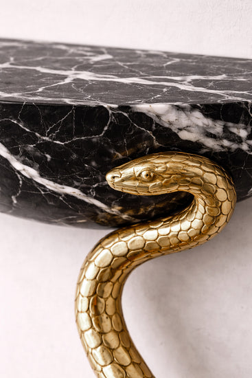 High-end marble console table with handcrafted serpent legs by Hekla Property.