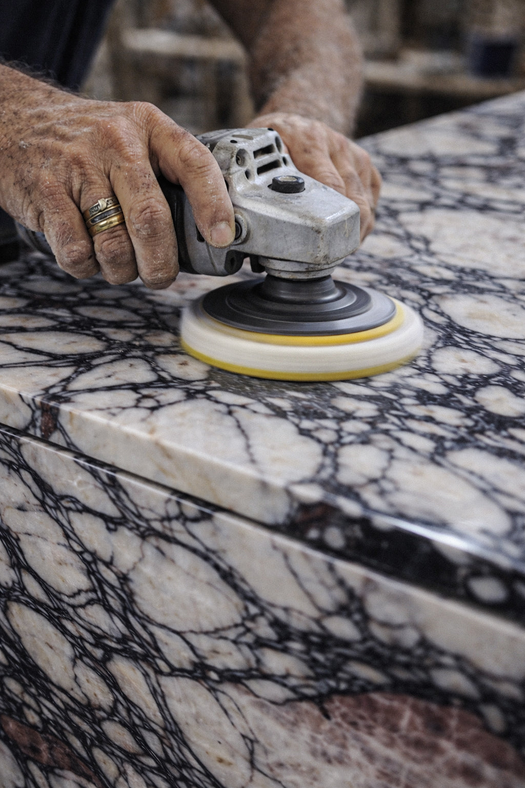 Person using a diamond sander on a marble surface