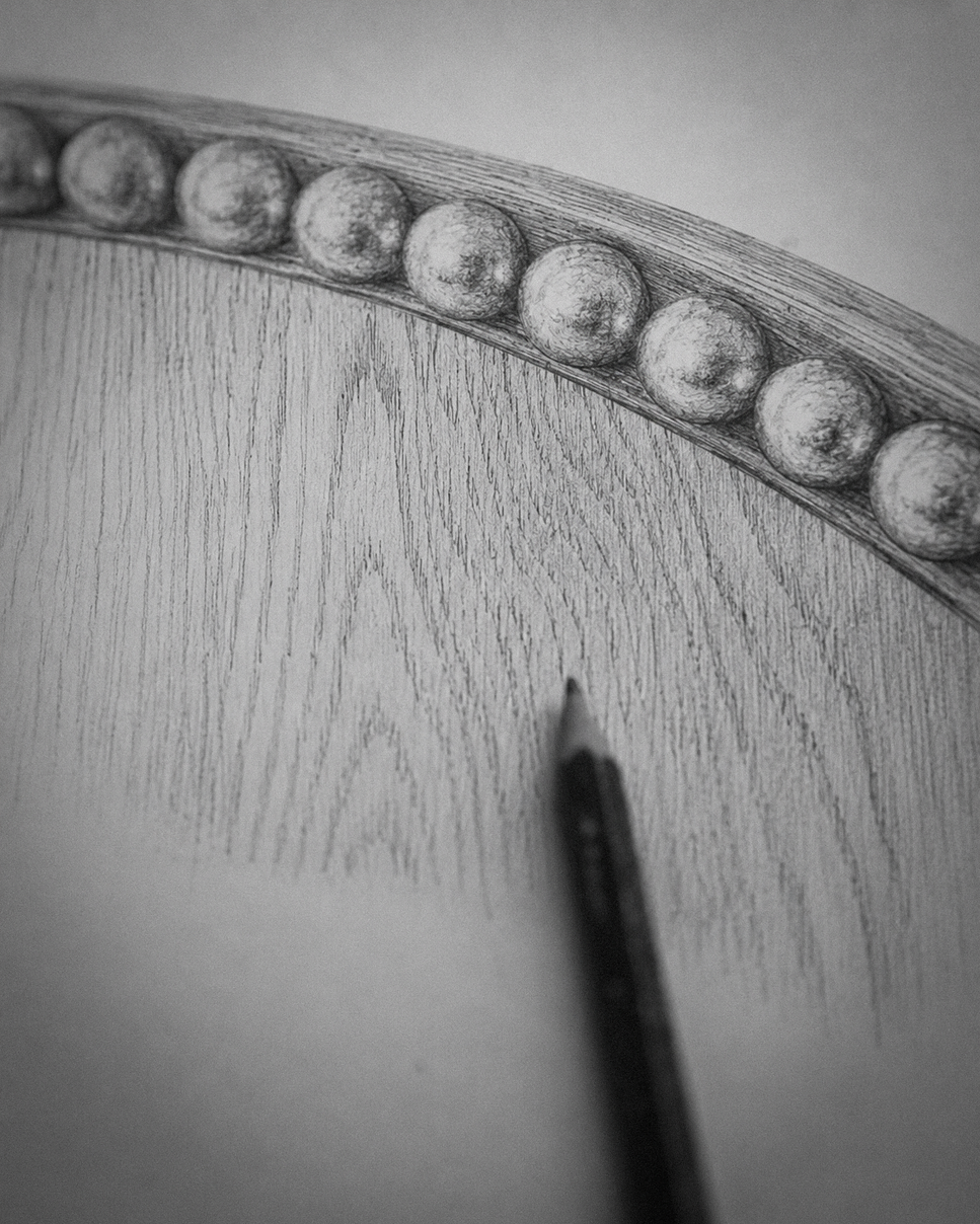 Close-up of a pencil drawing on paper with decorative elements.