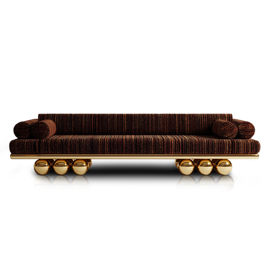 Handmade designer sofa with sculptural gold base and modern silhouette.