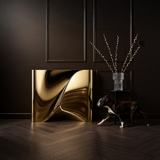 Luxury modern console table in high-gloss gold metal surface reflecting light elegantly.